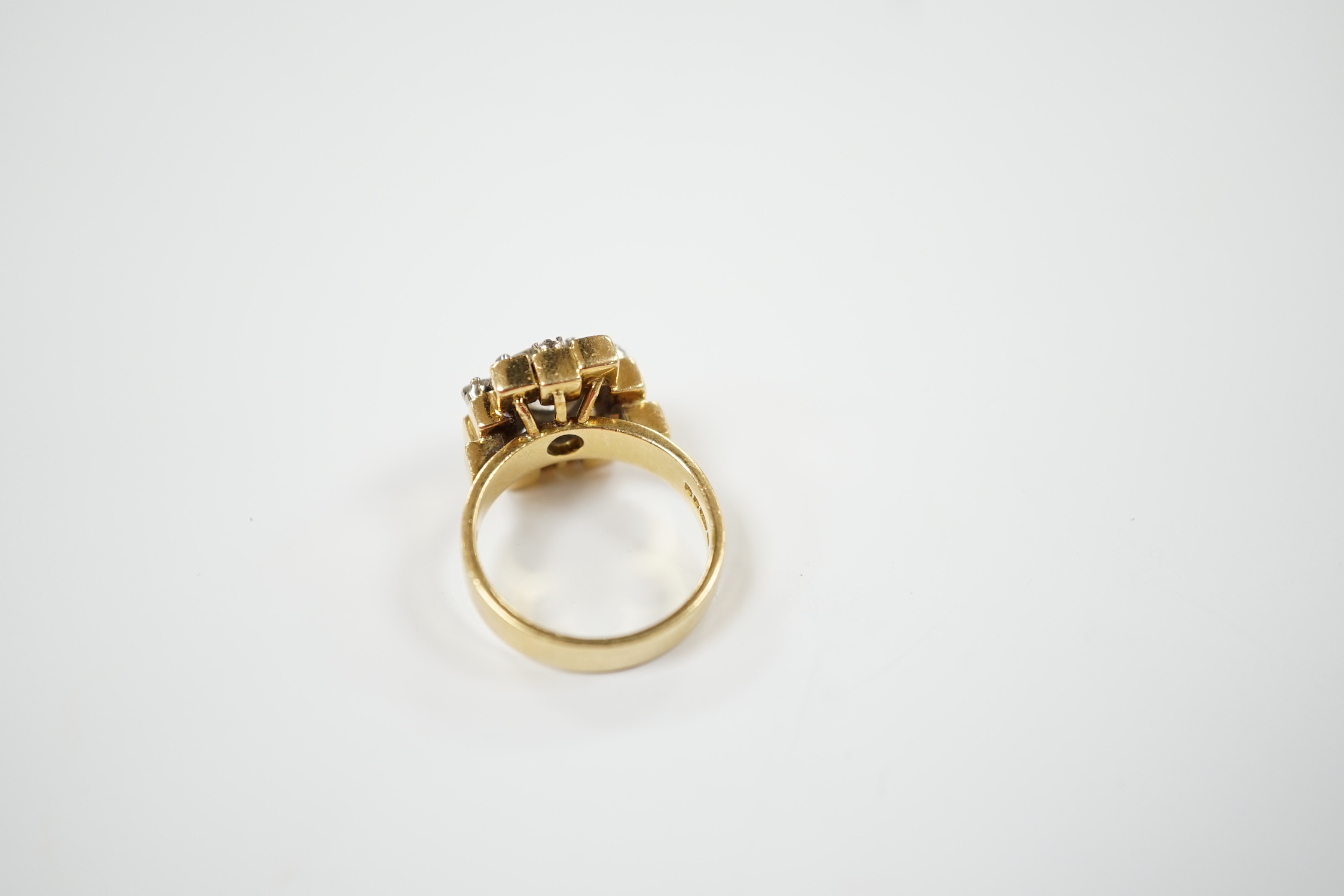 A 1970's 18ct gold and single stone diamond set ring, with five stone diamond mounted setting, size L, gross weight 10.1 grams, the central stone weighing approximately 1.40ct.